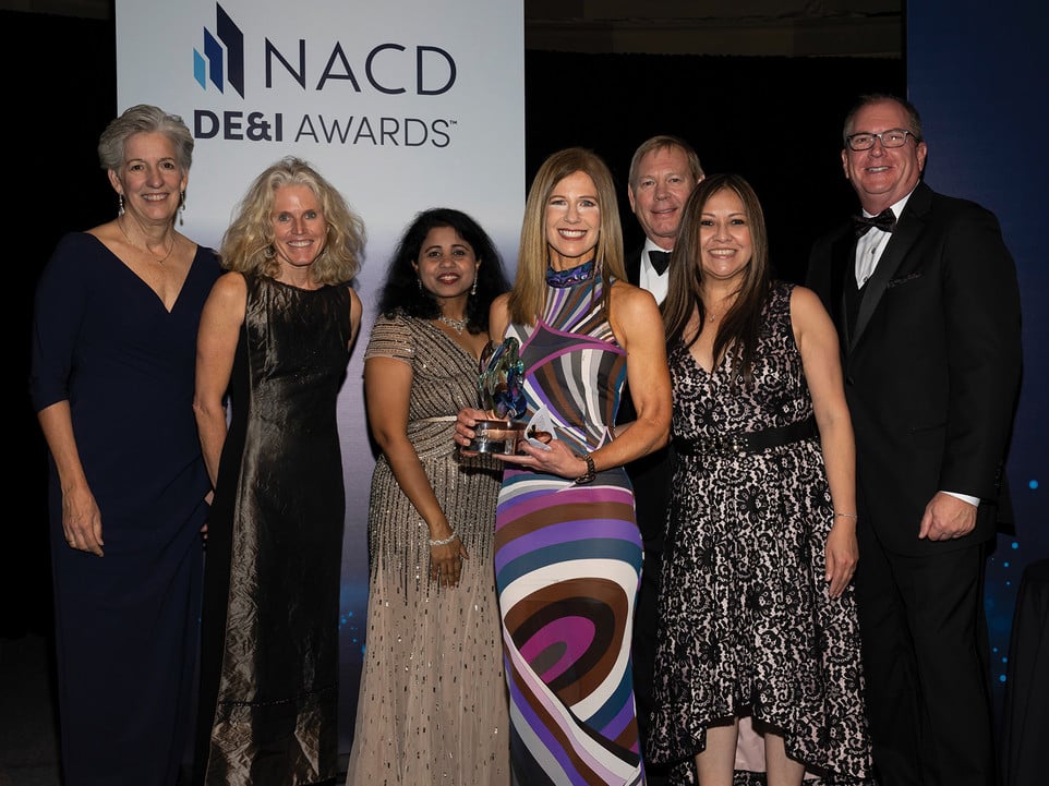 The AMN Healthcare team stands with NACD president and CEO Peter R. Gleason at the 2022 NACD DE&I Awards Gala.