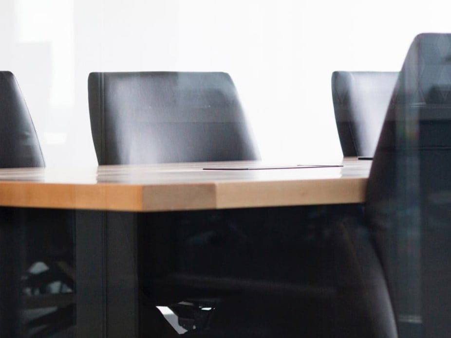 Empty boardroom with large conference table, representing resources for board directors