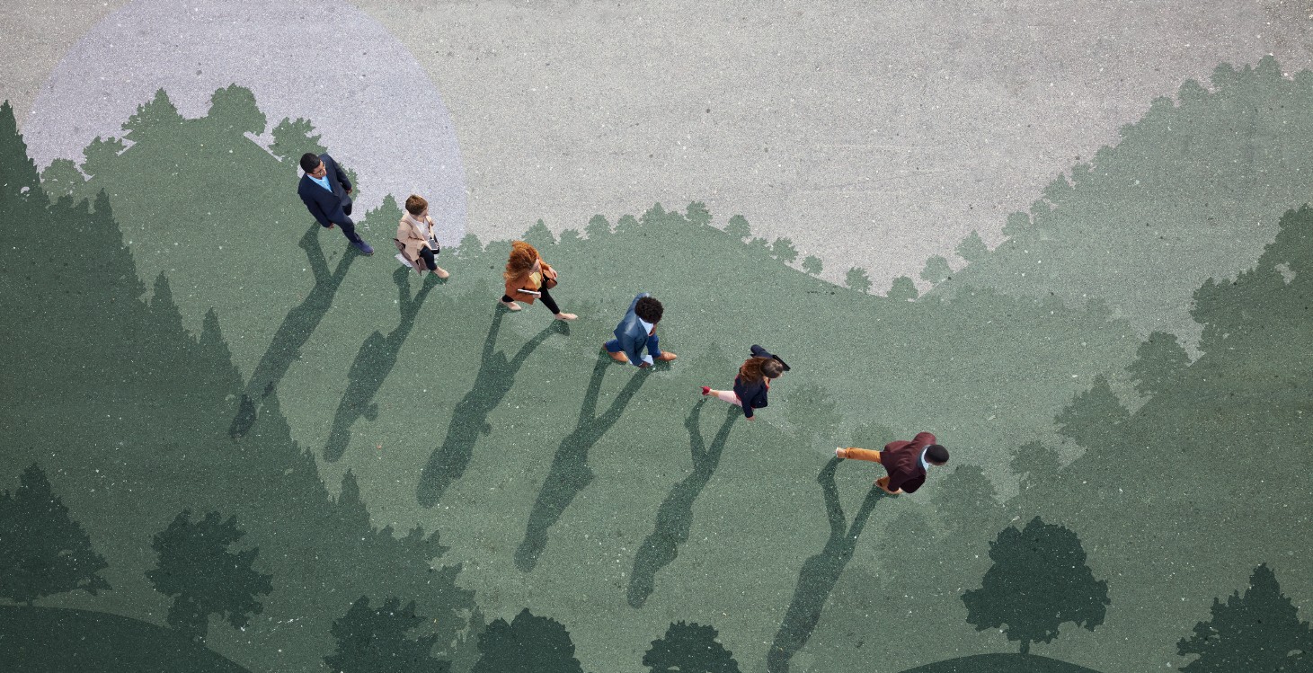 Businesspeople walking down hill side, painted on asphalt